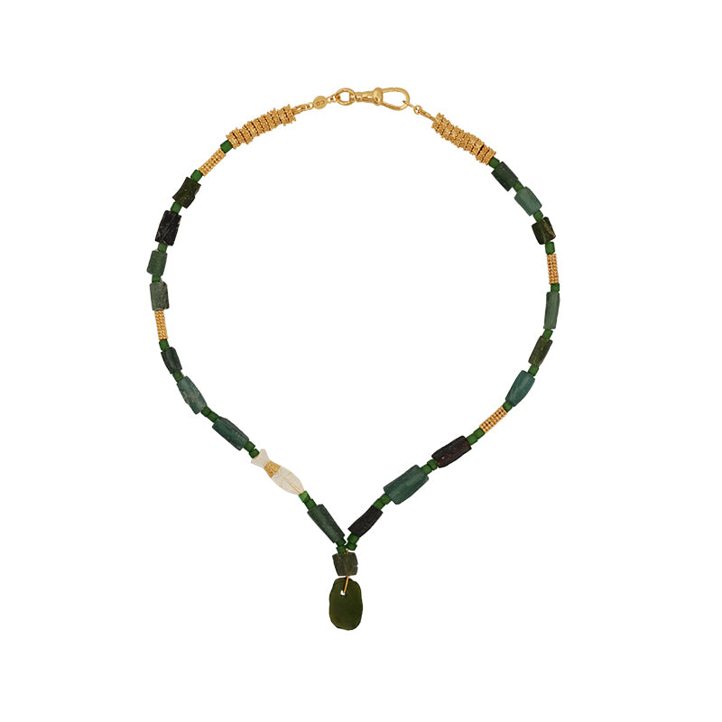 A beaded necklace featuring dark green rectangular beads, small gold spacer beads, a white accent bead, and a dark green teardrop pendant, displayed on a solid white background.