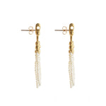 Crotalia Crucifix - Gold cross-shaped earrings with pearl tassel details seen from the side.